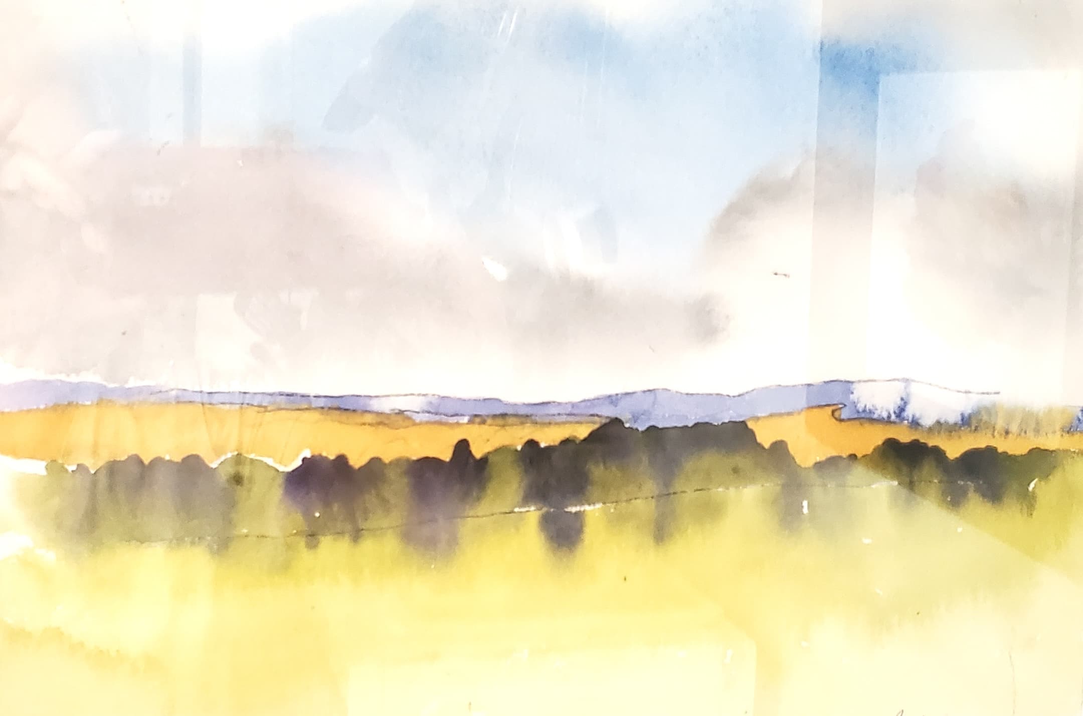 Abstract watercolor landscape with yellow fields, a dark treeline, and blue hills under soft clouds.