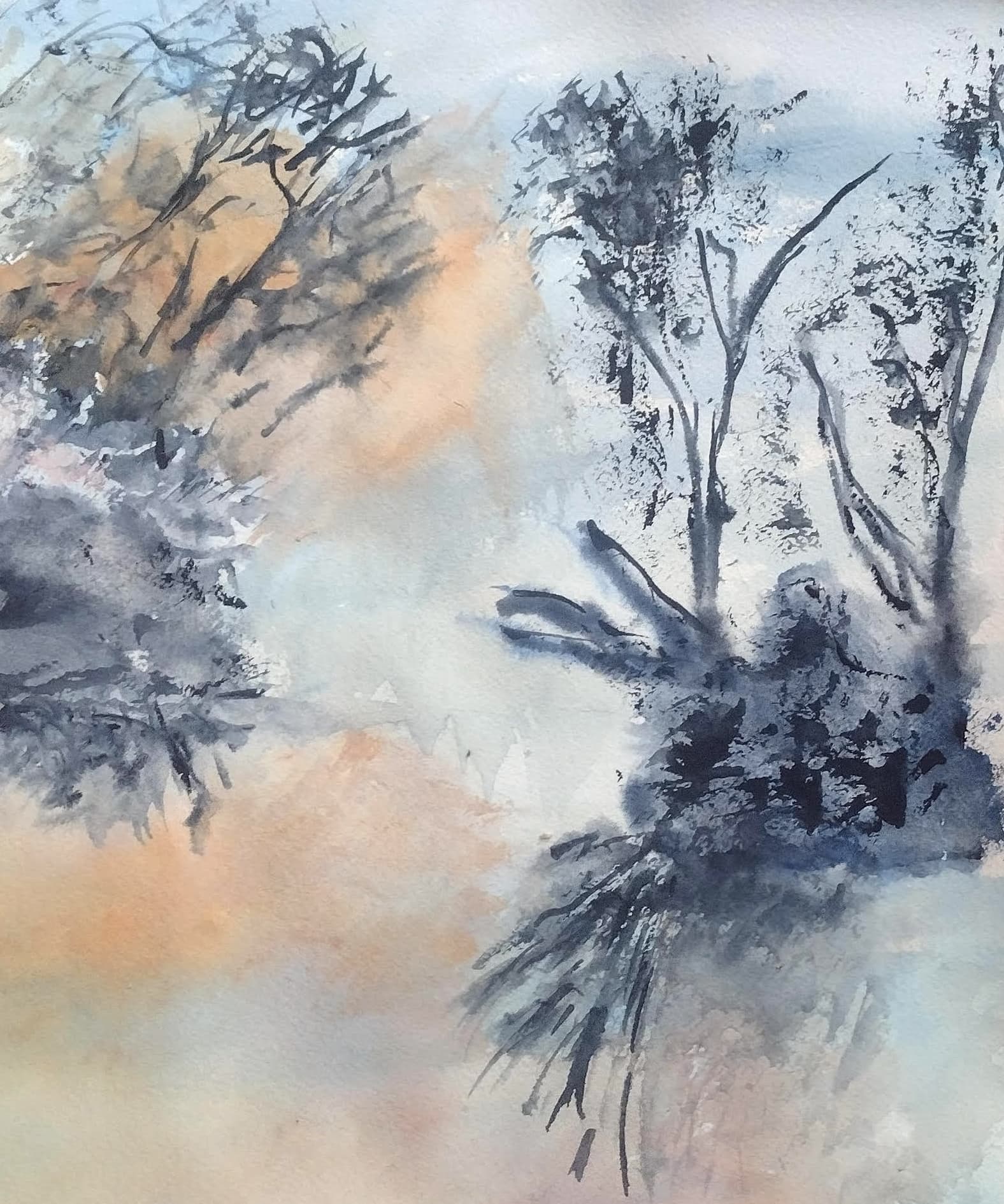 Abstract watercolor painting of dark, silhouetted trees against soft peach and blue atmospheric washes.